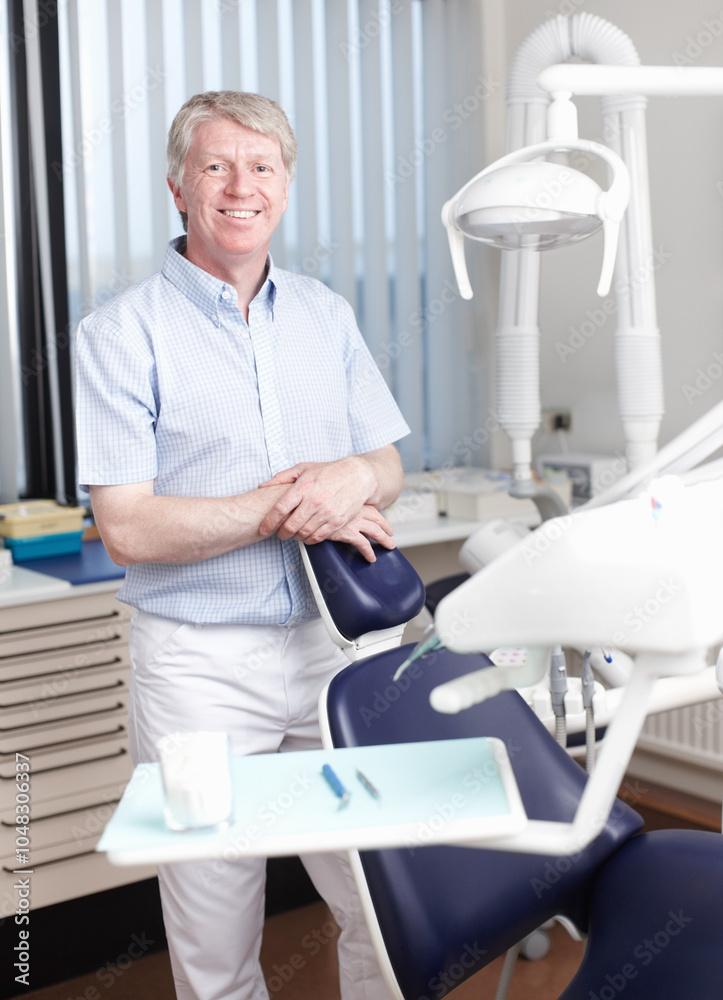 Happy man, dentist or portrait in office for healthcare, business or friendly welcome. Mature orthodontist, smile or about us in private practice with pride for knowledge in oral hygiene in Canada Happy man, dentist or portrait in office for healthcare, business or friendly welcome. Mature orthodontist, smile or about us in private practice with pride for knowledge in oral hygiene in Canada