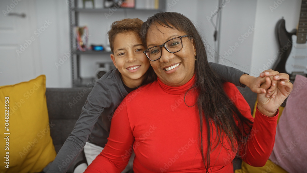 Fototapeta premium A smiling woman and boy embrace warmly in a cozy living room, reflecting a loving family bond.