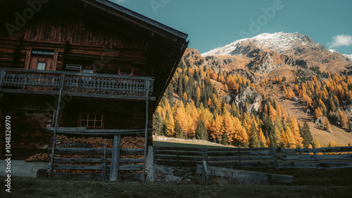 Obraz na płótnie Stunning autumn mountain scenery in the Alps with old farmhouse golden larches in fall w salonie