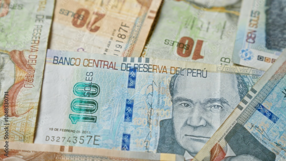 Obraz premium Peruvian banknotes featuring various denominations and designs are spread out in a detailed close-up of peru's legal tender, emphasizing the banco central de reserva del perÃº.