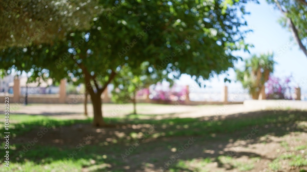 Outdoor space featuring blurred greenery, bokeh effect, and defocused natural background capturing trees, grass, sunlight, and shadows Outdoor space featuring blurred greenery, bokeh effect, and defocused natural background capturing trees, grass, sunlight, and shadows