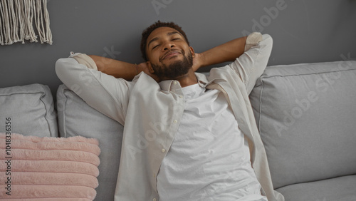 Handsome man relaxing indoors in a modern living room setting