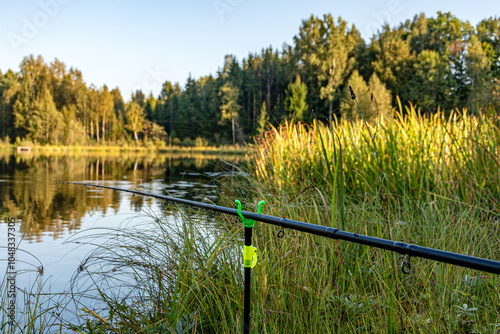 a beautiful landscape with a small forest lake, a fisherman's view of the lake, various fishing attributes photo