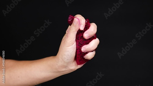 Squeezing Dragon Fruit in Hand