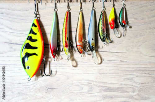 Set of fishing lures for predatory fish, on wooden background photo