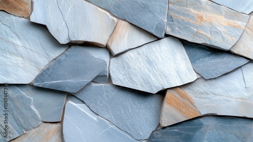 A collage of blue and gray stones mixed with hints of brown, forming an artistic wall design, reflecting nature's blend of colors and textures. photo