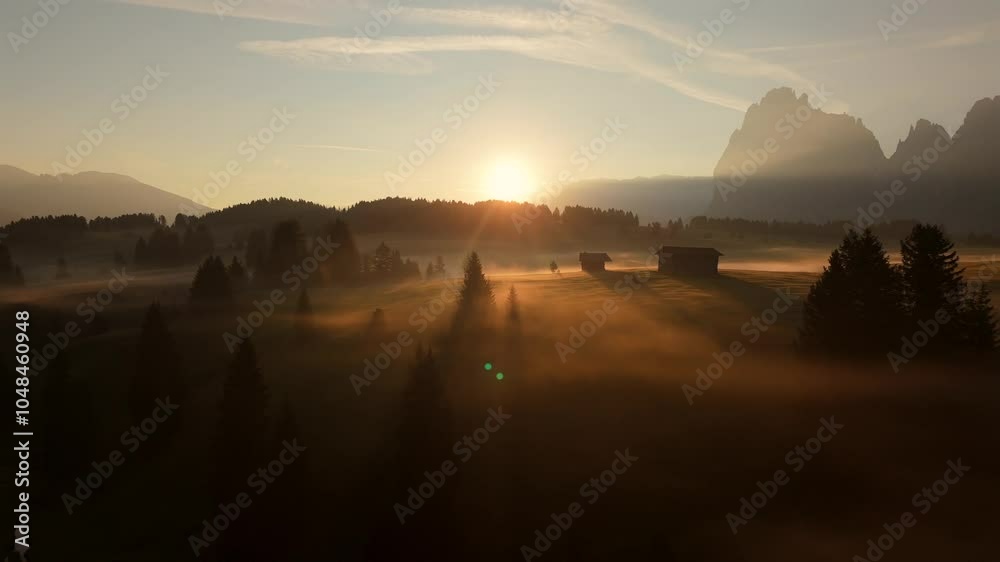 custom made wallpaper toronto digitalSunrise illuminates the mist-covered fields of Seiser Alm with soft golden light, casting shadows across the landscape and highlighting trees and rustic buildings in the Dolomites.