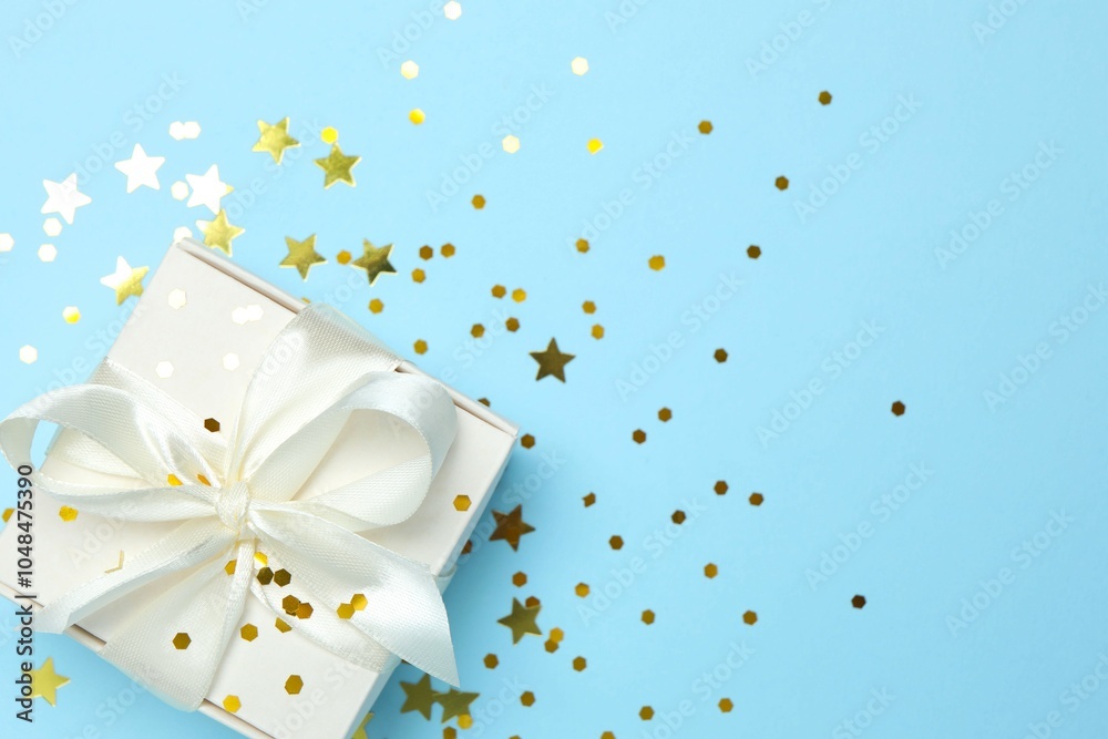 Beautiful gift box tied with bow on color background 