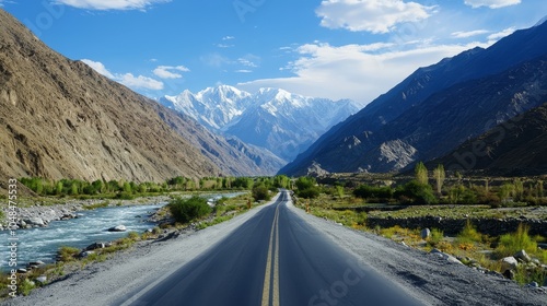 Scenic Mountain Roadway with River and Majestic Peaks