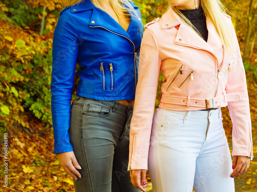 Two women walking in autumn park photo