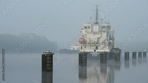 Frachtschiff fährt bei Nebel im Nord-Ostsee-Kanal  photo