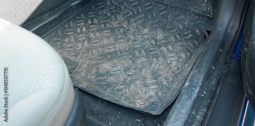 Dirty car floor mat in auto. photo