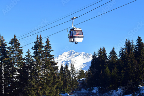 Vintage Ski gondola over the slopes of Courchevel ski resort, French alps