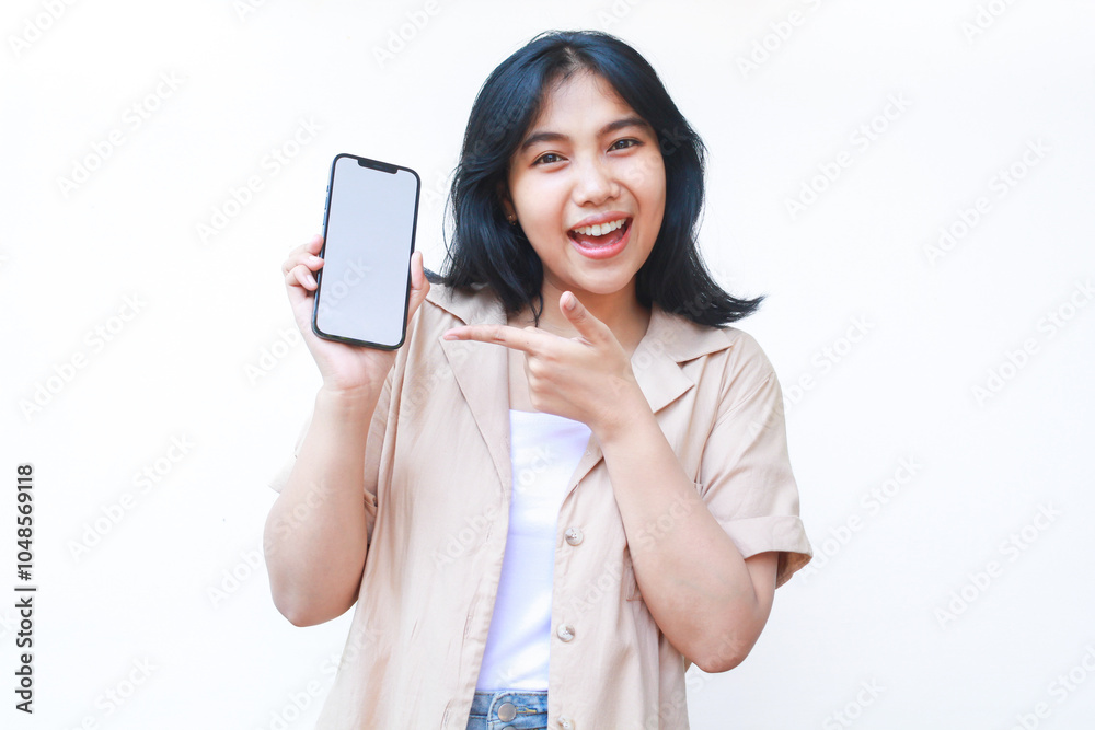 custom made wallpaper toronto digitalexcited asian woman do presenting gesture with pointing finger to smartphone white screen wearing brown casual clothes isolated on white background