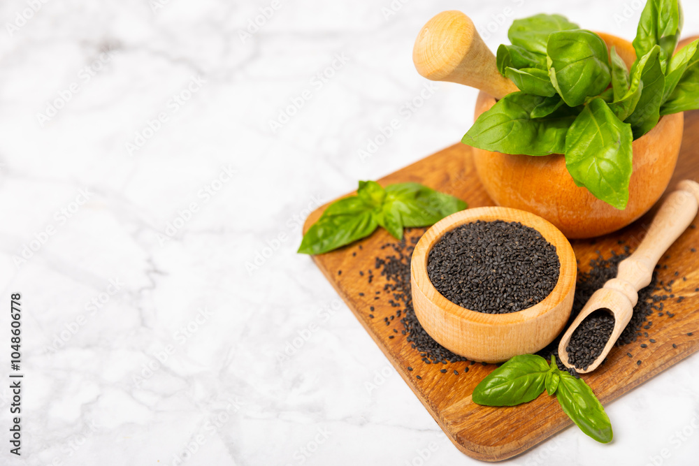 Basil seeds on textured wooden background. Close-up. Superfood. Ocimum basilicum. Organic basil seeds. selasih. Space for text. Copy space. Basil seeds on textured wooden background. Close-up. Superfood. Ocimum basilicum. Organic basil seeds. selasih. Space for text. Copy space.