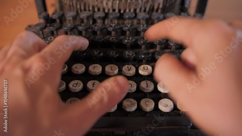 Young man's hands typing on an antique vintage typewriter