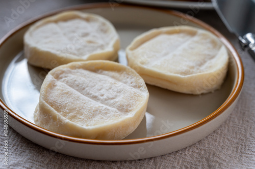 Rocamadour or cabecous soft goat AOC cheese with soft rind produced on farm in Perigord and Quercy on farmers market, departement Lot, France photo