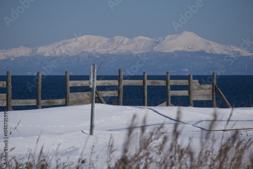 snow covered mountain landscape with fence