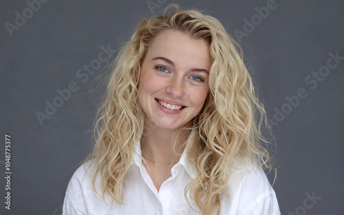 blonde woman with curly hair smiling