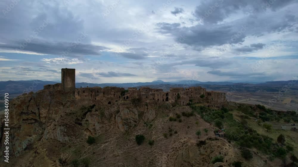 4K Aerial drone video of mystical ghost town on top of the hill with ruins and empty houses. Haunted village with crumbling structures and fallen church. Abandoned city Craco, Matera, Italy 4K Aerial drone video of mystical ghost town on top of the hill with ruins and empty houses. Haunted village with crumbling structures and fallen church. Abandoned city Craco, Matera, Italy