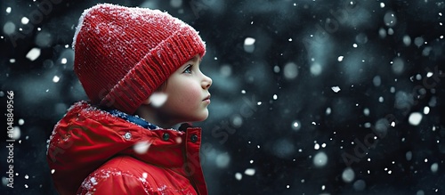 A boy wearing a red jacket ...