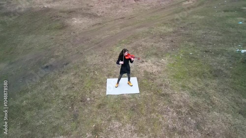 Aerial Top Down Push in to Violin Player Practicing Outdoors