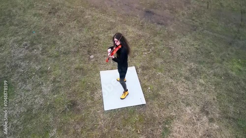 Aerial Push In Top Down to Violin Player Practicing Outdoors