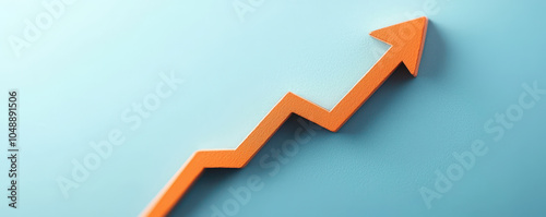 close up view of orange upward arrow on light blue background symbolizes growth and progress, representing positive trends in various fields