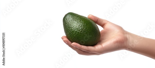 Avocado held in hand agains...
