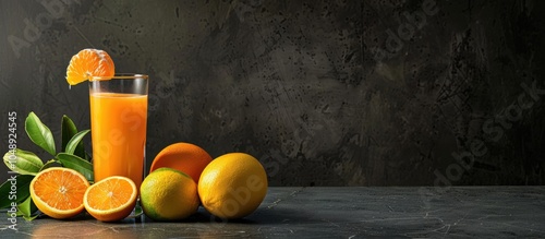 A glass of fruit juice accompanied by fresh citrus fruits. with copy space image. Place for adding text or design photo