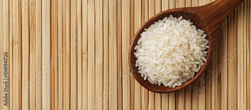 Raw rice in a wooden spoon ...