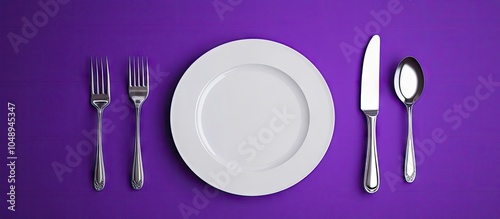Cutlery on a purple backdro...