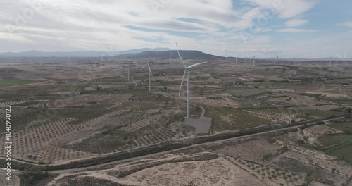 Aerial drone shot of wind turbines at a wind farm in Catalonia outside of Barcelona, Spain, Europe on bright sunny day. Shot in 5K ProRes 422 HQ photo