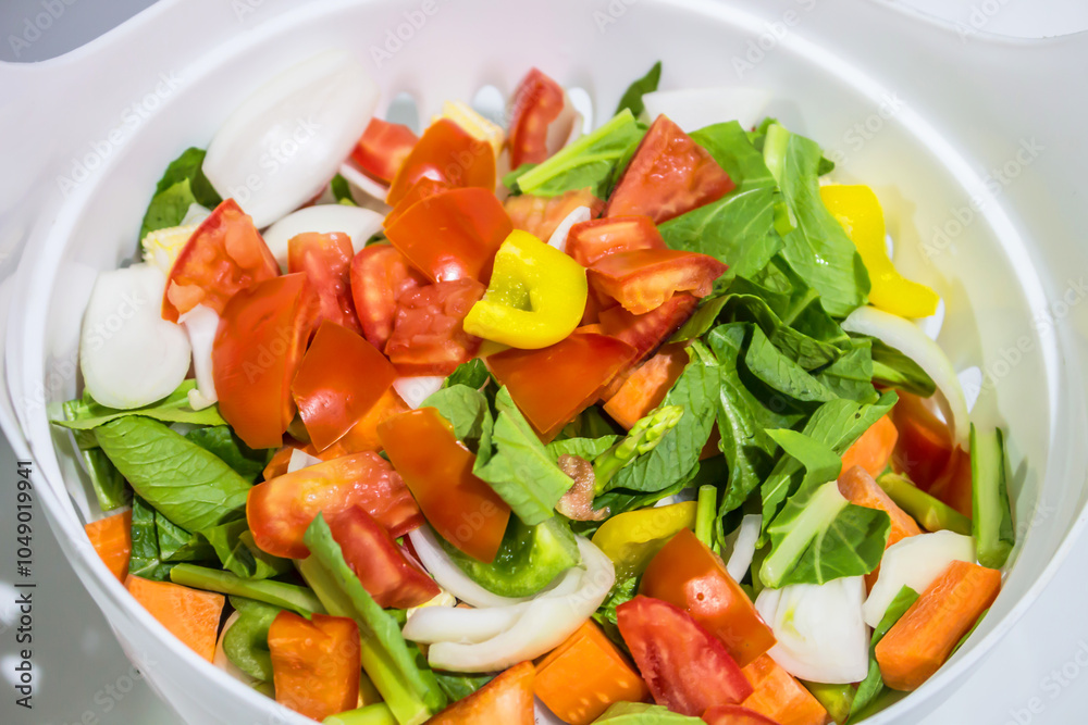 chopped raw vegetables in a white basket. chopped raw vegetables in a white basket.