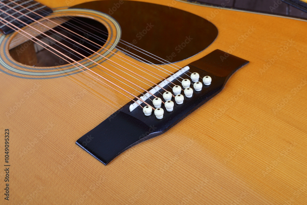 Fototapeta premium Musical instrument - Closeup fragment Vintage twelve-string acoustic guitar bridge