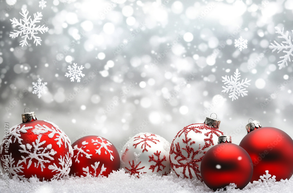 Red and white Christmas ornaments rest in a snowy scene