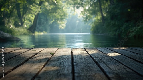 Wooden bridge over a river with trees in the background. The water is calm and the sun is shining on the bridge