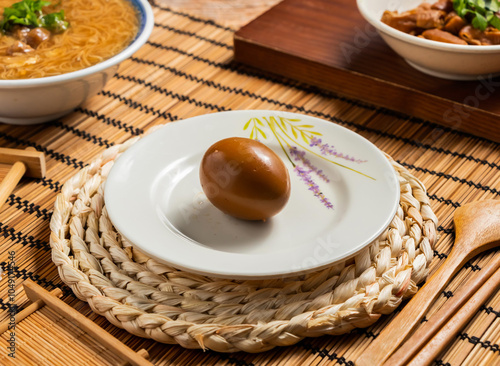 spiced corned egg with chopsticks and spoon served in plate isolated on mat side view of taiwan food photo