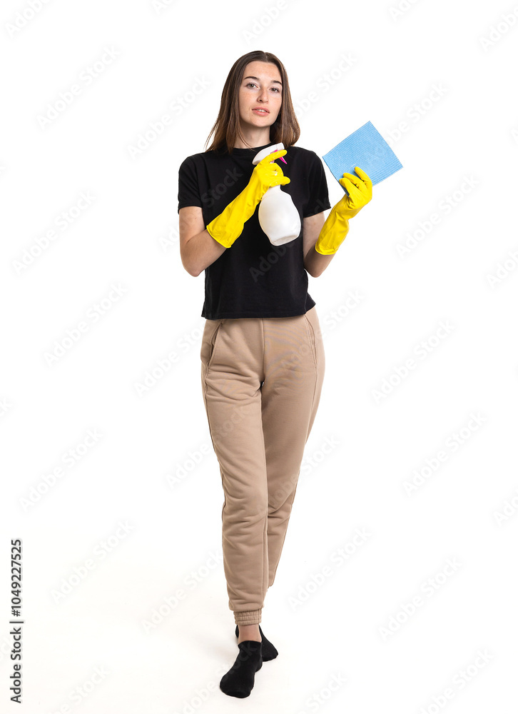 A young woman prepares to clean with a spray bottle and cloth, wearing yellow gloves in a bright and clean space A young woman prepares to clean with a spray bottle and cloth, wearing yellow gloves in a bright and clean space