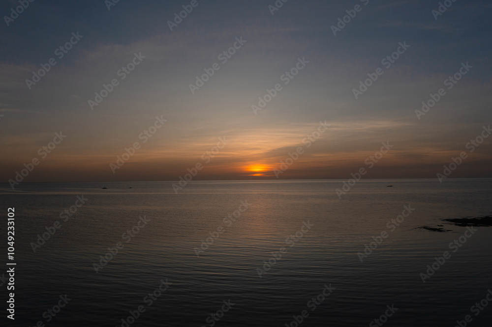 Serene view of sea surface with sunset background. Sunset in Bantayan, Madridejos, Cebu. Philippines. Serene view of sea surface with sunset background. Sunset in Bantayan, Madridejos, Cebu. Philippines.