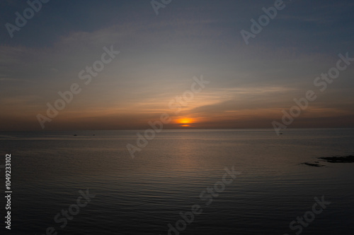 Fototapeta Naklejka Na Ścianę i Meble -  Serene view of sea surface with sunset background. Sunset in Bantayan, Madridejos, Cebu. Philippines.