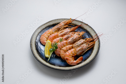 Quadro su tela Grilled prawns with herbs and lemon, served on a ceramic plate