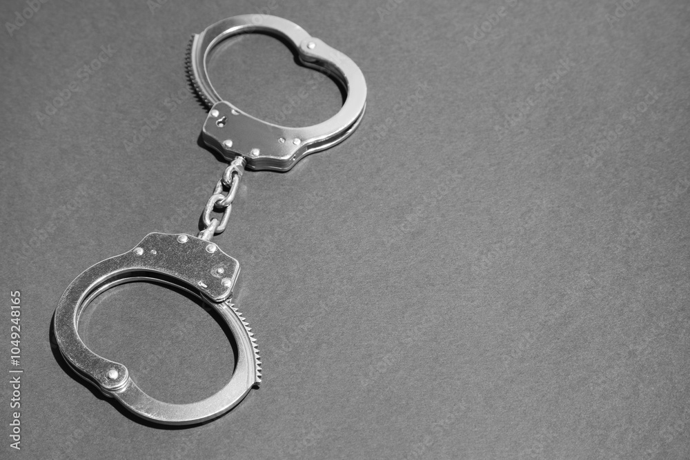 Classic chain handcuffs on black background, closeup. Space for text Classic chain handcuffs on black background, closeup. Space for text