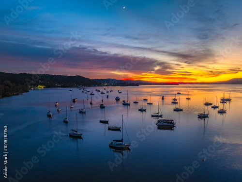 Aerial sunrise waterscape with boats and high cloud photo