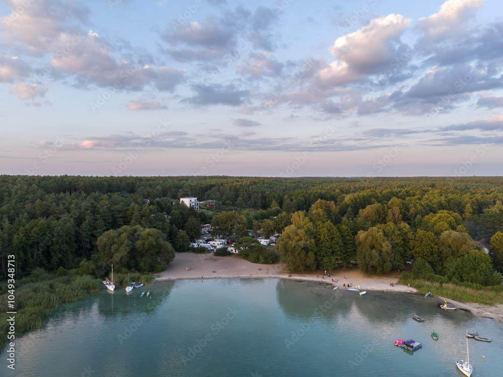 Aerial landscape skyline view of Powidz lake and Anastazewo beach (Jezioro Powidzkie, Plaża Anastazewo) at sunset. Popular summer resort in Wielkopolska, Poland