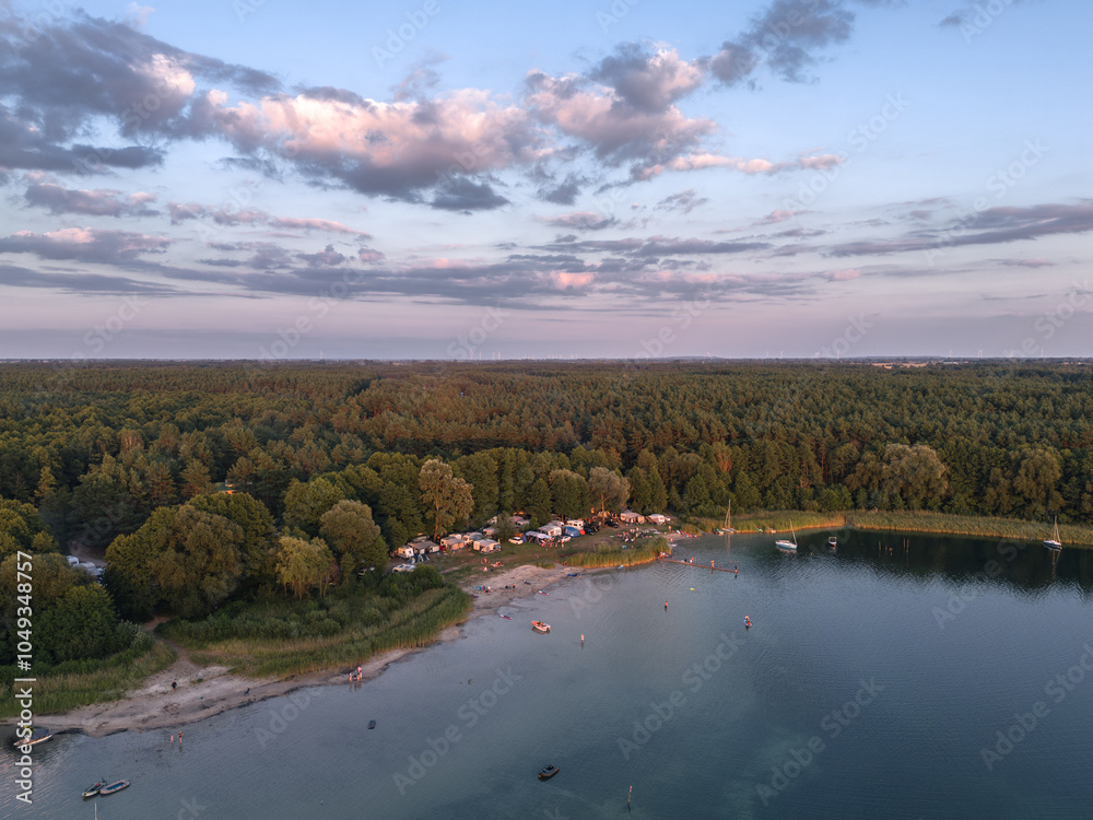 Aerial landscape skyline view of Powidz lake and Anastazewo beach (Jezioro Powidzkie, Plaża Anastazewo) at sunset. Popular summer resort in Wielkopolska, Poland