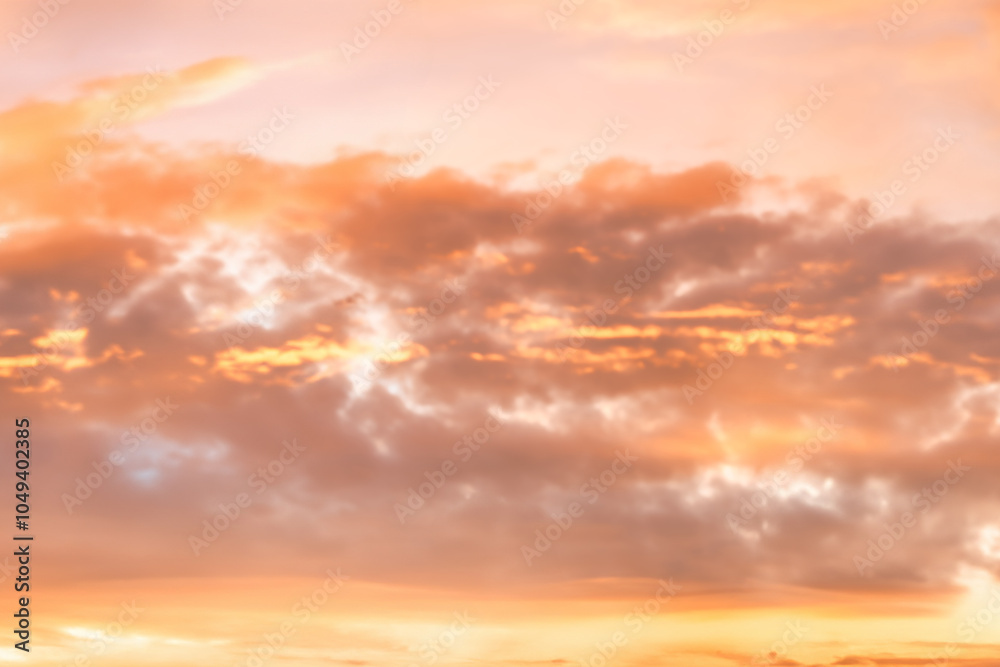 A beautiful sky tinted by the sun leaving vibrant shades of gold, pink, blue and multicolored. Clouds in the twilight evening and morning sky. Cloudy sky background in the evening, and during the day.