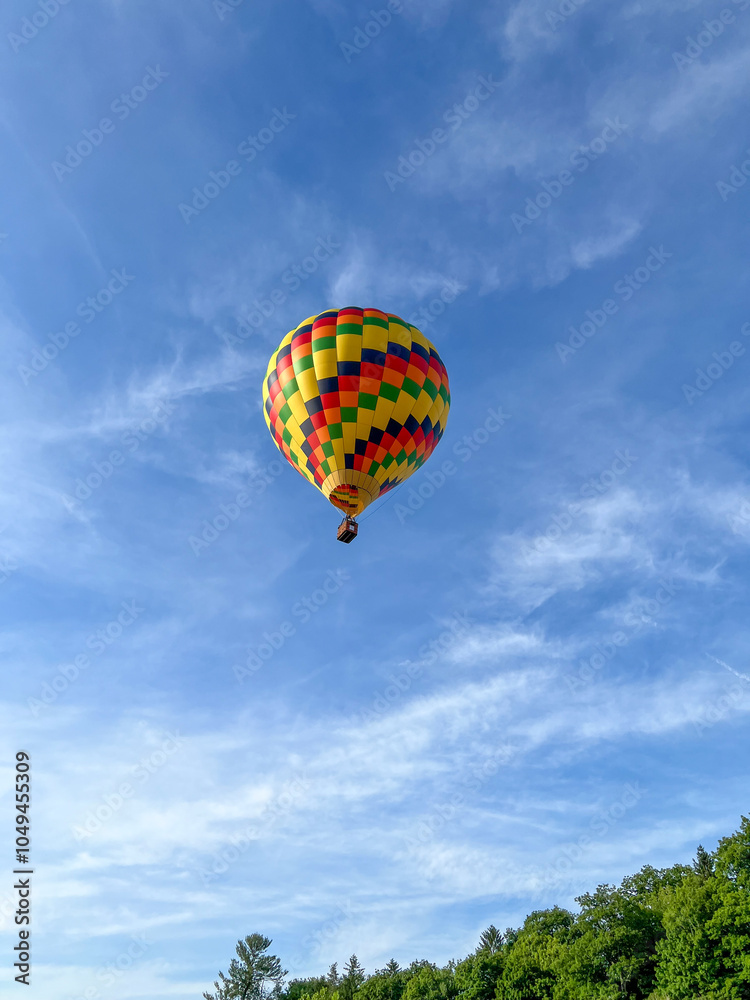 Colorful Hot Air Balloon on Blue Sky Flying Over Green Trees Colorful Hot Air Balloon on Blue Sky Flying Over Green Trees