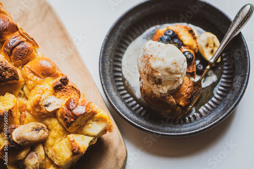 Baked bread pudding with ice cream and fruits photo