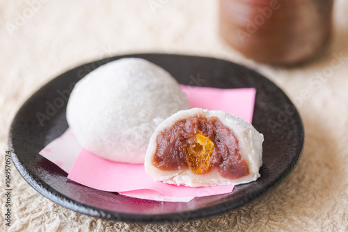 Manju sweet on black plate photo